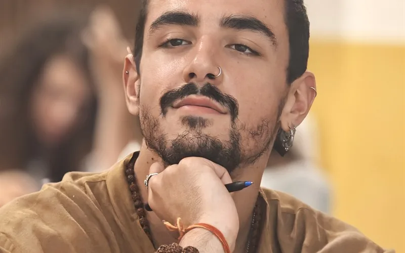 A young devotee listening thoughtfully