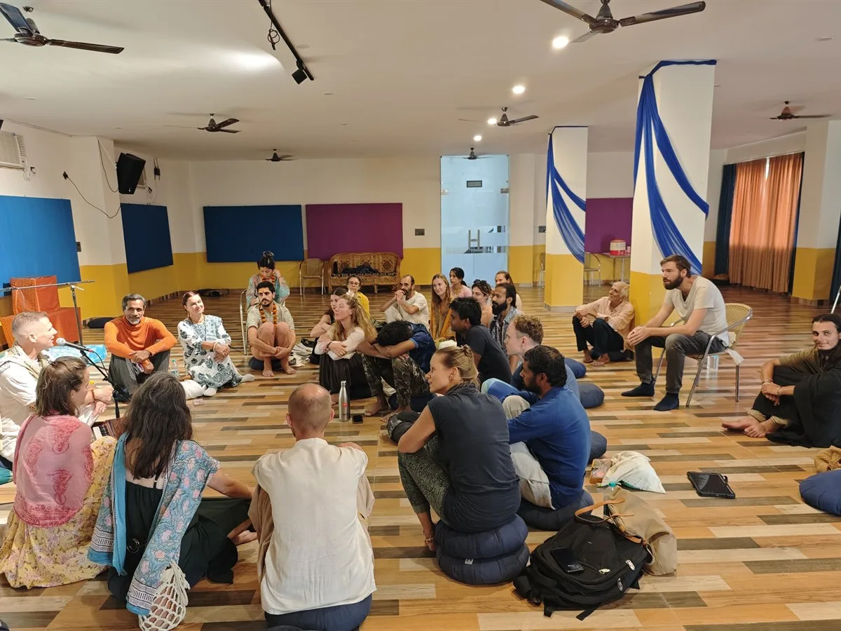The community standing together in a circle during an ashram gathering