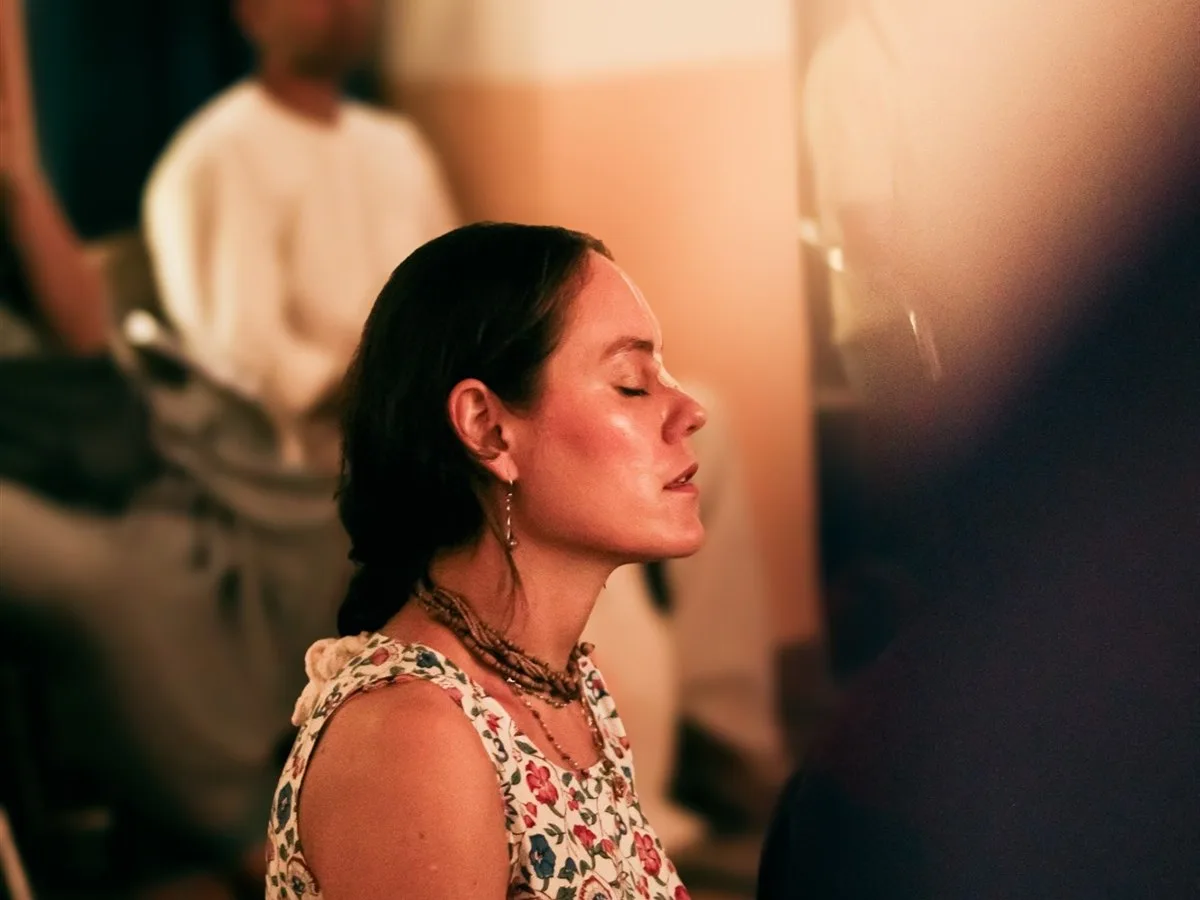 Eyes closed and hand on heart, absorbed in the evening chant