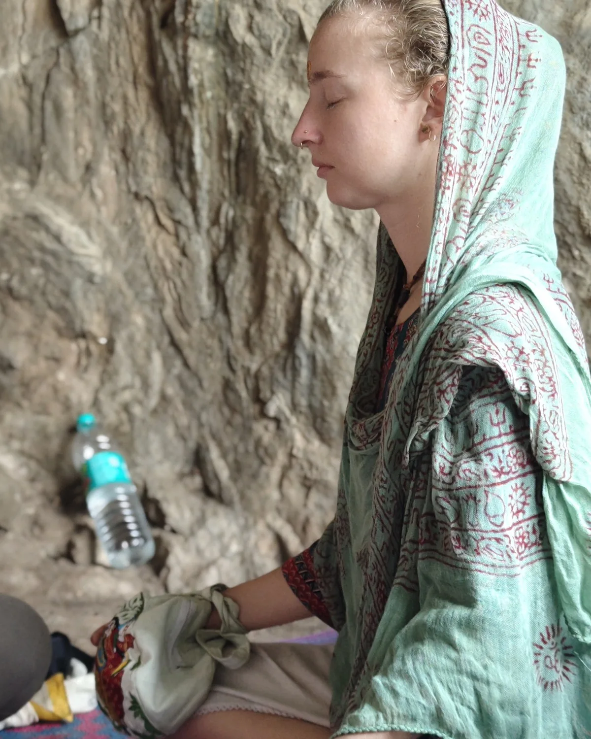 A woman in meditation at the ashram