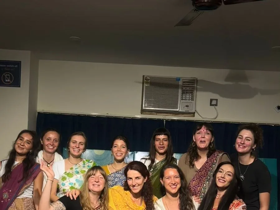Friends sharing a joyful moment by the Ganga