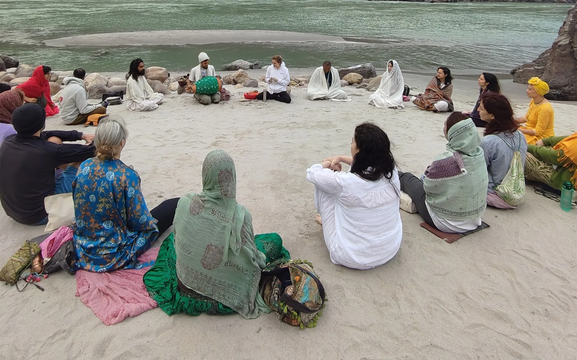 The retreat circle gathered on the sand beside the Ganga at sunrise